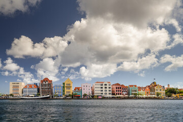 Naklejka premium Willemstad, Curazao, Netherland Antilles. November 26, 2013: Colorful waterfront buildings line the harbor in Willemstad, Cura�ao.