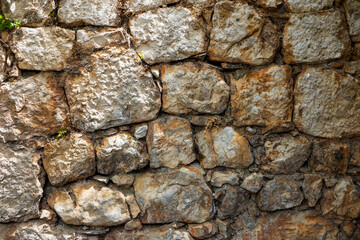 Ancient stone wall made of rough natural stone