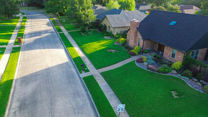 Quiet suburban street with wide sidewalks in Coppell, suburbs Dallas, Texas featuring upscale single-family homes, mature trees, and manicured lawns in a peaceful, walkable neighborhood setting