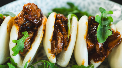 Fluffy steamed bao buns filled with succulent pulled pork, drizzled with smoky barbecue sauce and...