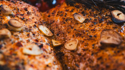 Close-up of perfectly roasted salmon fillet with crispy burnt garlic slices, vibrant cherry tomatoes, and fresh rosemary. A rustic, healthy gourmet meal, ideal for food blogs, recipes, and culinary br