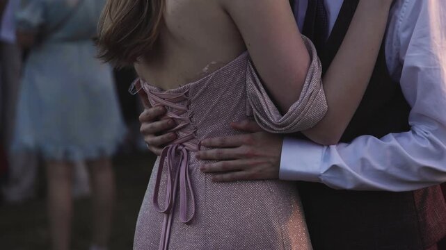 High school graduates dancing on prom, waltz and classical ball dance in dresses and suits on school graduation party, girls and boys classical ballroom dancers, couples dance quadrille and polonaise