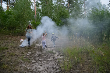 Family Playing and Running Through Smoke in Forest Nature