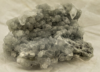 Extensive quartz formation featuring transparent points emerging from a rough green matrix. Captured in soft light, perfect for geology-themed projects, crystal product photography