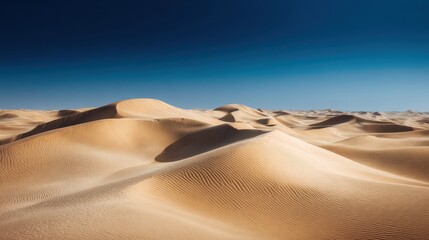 Naklejka premium A 4K photo of windswept sand dunes in stark desert landscape under expansive blue sky.
