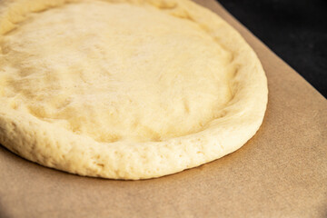 Raw pizza dough making pizza base tasty snack fresh delicious gourmet food background on the table rustic top view copy space