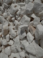 Texture, background of small white pebbles with sparkles for flower garden, garden decor