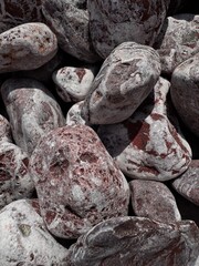 Embossed texture of purple and white stones background