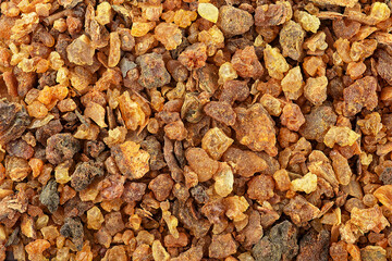Aromatic yellow Myrrh resin as background, top view. Sudanese Frankincense tree. Incense, fragrances.