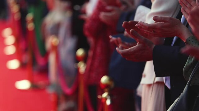 Actors, celebrities and stars on red carpet, guests and fans cheer an clapping hands, welcome, applause and ovation on cinema movie premiere, film festival award ceremony, ropes and golden barriers