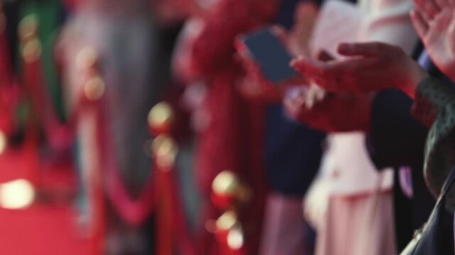 Actors, celebrities and stars on red carpet, guests and fans cheer an clapping hands, welcome, applause and ovation on cinema movie premiere, film festival award ceremony, ropes and golden barriers
