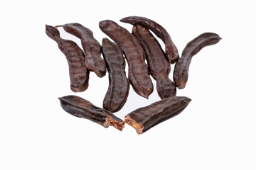Group of dried carob pods isolated on white background