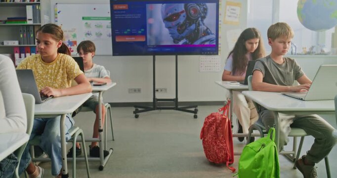 Primary School Students Working on Creative Projects on Laptops, Practicing Digital Skills in Art Class. Digital Screen Showing AI Software for Creating Pictures. Interactive STEM Learning. Dolly Shot