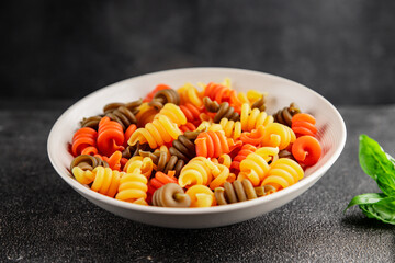 pasta trottole tricolor pasta spiral dish twisted Italian food tasty snack fresh delicious gourmet food background on the table rustic top view copy space  vegan and vegan food