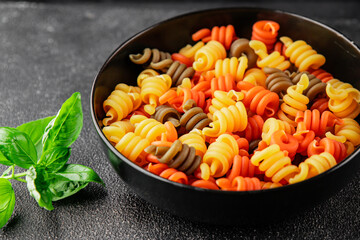 pasta trottole tricolor pasta spiral dish twisted Italian food tasty snack fresh delicious gourmet food background on the table rustic top view copy space  vegan and vegan food
