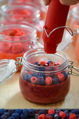 Handmade soy candles making process with wax berries decoration