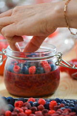 Handmade soy candles making process with wax berries decoration