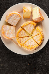 Cheese plate camembert, brie, munster french cheese tasty snack fresh delicious gourmet food background on the table rustic food top view copy space