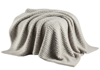 A soft, textured, light beige blanket draped elegantly, showcasing a cozy and inviting style.