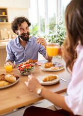 Couple enjoying breakfast in a bright kitchen