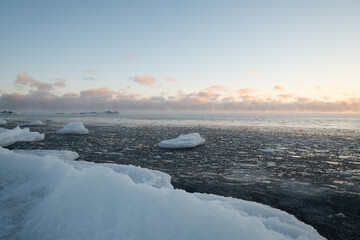 Frozen cove on Lake Superior with floating ice and snowy shoreline
