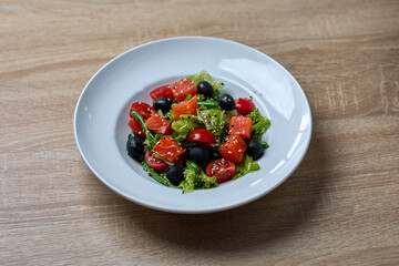 Fresh vegetable salad with olives and tomatoes
