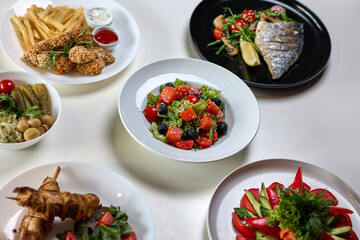Variety of fresh salads and gourmet meals on table