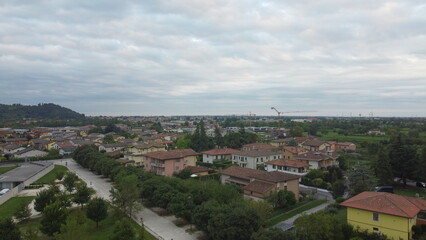 Fototapeta premium Aerial view of the town of Botticino Sera, Brescia, Italy with green fields and from above with a drone
