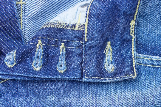 texture of buttonhole on blue cotton denim pants