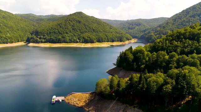 Barajul Vidraru Dam on Transfagarasan Highway, Romania. Aerial panoramic drone view from above, top view from drone . Summer holidays in Europe. The most beautiful road in the world, amazing scenery v