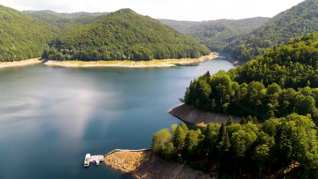 Barajul Vidraru Dam on Transfagarasan Highway, Romania. Aerial panoramic drone view from above, top view from drone . Summer holidays in Europe. The most beautiful road in the world, amazing scenery v