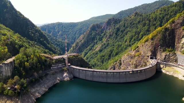 Barajul Vidraru Dam on Transfagarasan Highway, Romania. Aerial panoramic drone view from above, top view from drone . Summer holidays in Europe. The most beautiful road in the world, amazing scenery v