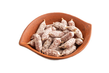 Small smoked Chicken sausages in clay bowl isolated on white. side view, close up