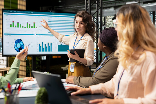 Multiethnic businesswomen group working on development plans and strategic thinking together in office space, reflecting visionary objectives alignment in business environment. - Powered by Adobe