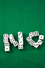 In a game environment, various white dice are positioned to form the word no against a green felt background. The setup showcases a playful rejection during gameplay.