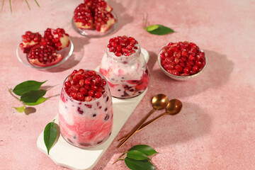 Pomegranate yogurt in fresh cream glasses and fresh cherries on elegant table, detox diet and natural food concept, healthy breakfast with ingredients.healthy lifestyle advertisement, baby food.