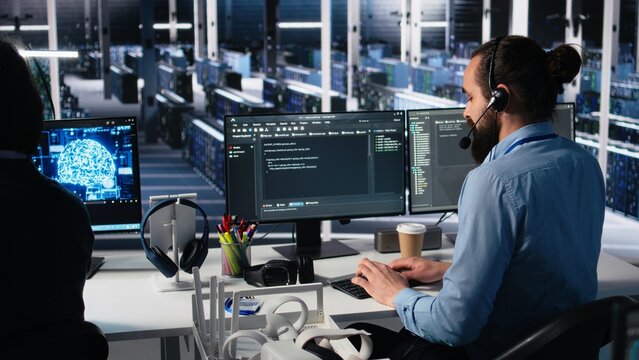 Data center admin using AI assistant to provide user technical support and solutions to users. Server farm IT expert managing live support calls assisted by artificial intelligence chatbot, camera A