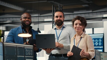 Team of office workers collaborating on project planning and briefing, using data from charts on tablet to drive performance metrics. Fostering teamwork and a workplace partnership.