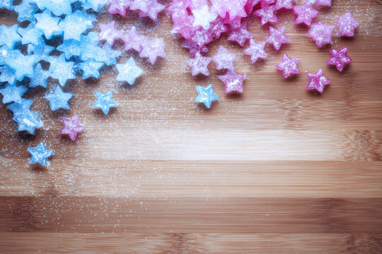 Blue star candy, pink star candy, and white sugar crystals scattered on wooden cutting board create dreamy pastel gradient with playful, whimsical mood - Powered by Adobe