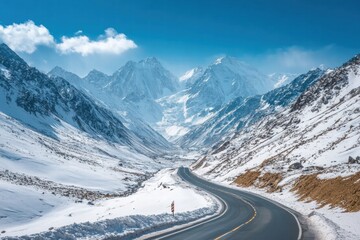 Scenic alpine road surrounded by snowy peaks