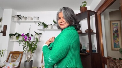 Woman showing off her handmade green crochet cardigan