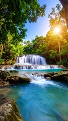 Obraz premium Lush waterfall cascading through tropical forest