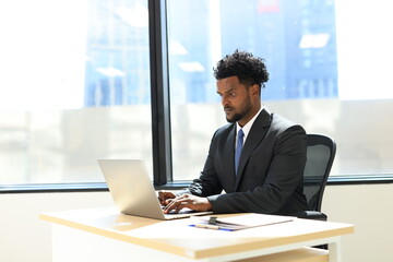Diverse Team Working Together in Modern Co-Working Space. Casual meeting of smiling diverse business team analyzing financial data. Multiethnic business people working together in the office.