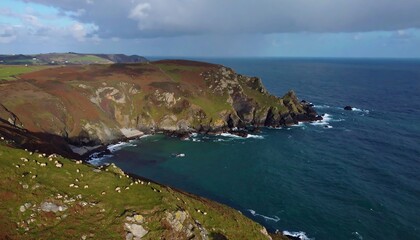 Dramatic Coastal Cliffs Meeting the Deep Blue Sea Under a Cloudy Sky.