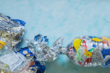 Eco-brick made from plastic waste on blue background