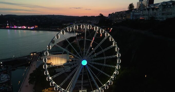 Bournemouth Ferris wheel and illuminated path at sunset