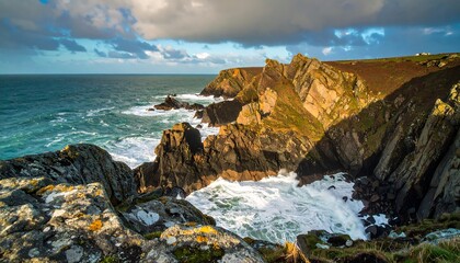 Obraz premium Dramatic Cornish Coastline: Crashing Waves against Rocky Cliffs in Sunlight