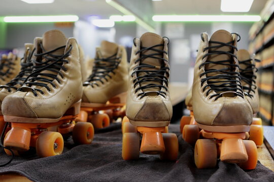 Roller skates on the rental counter at a roller rink.  