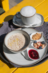 Reserved breakfast at a cafe. A plate of porridge on a table in a street cafe. 