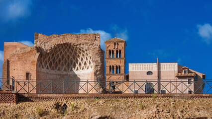 Rome historical center ancient architecture. Temple of Venus apse ruins and medieval bell tower viewed form Coliseum Square